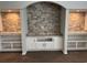 Living room with brick accent wall flanked by shelving on either side and white cabinets underneath at 71 Mohican Dr., Georgetown, SC 29440