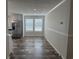 Open dining room with natural light, stainless steel fridge and wood-look floors at 71 Mohican Dr., Georgetown, SC 29440