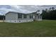 Well-maintained mobile home on a spacious lot featuring gray siding and black shutters at 71 Mohican Dr., Georgetown, SC 29440