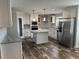 Modern kitchen with stainless steel appliances, marble countertops, and central island at 71 Mohican Dr., Georgetown, SC 29440
