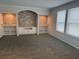 Bright living room showcases large windows, neutral decor, and a stylish accent wall with built-in shelving at 71 Mohican Dr., Georgetown, SC 29440