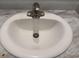 Close-up of a bathroom sink with a marble-look countertop at 71 Mohican Dr., Georgetown, SC 29440