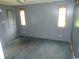 View of bedroom with wood paneled walls, three windows, and patterned blue carpet at 742 Se Hebron Dr., Conway, SC 29527