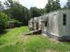 Exterior of the home, showcasing the expansive yard and surrounding greenery at 742 Se Hebron Dr., Conway, SC 29527