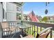 Cozy outdoor balcony featuring seating with views of the community and an American Flag at 7700 Porcher Dr. # 3205, Myrtle Beach, SC 29572