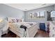 Comfortable bedroom featuring wood floors, a window and bright colored pillows and décor at 7700 Porcher Dr. # 3205, Myrtle Beach, SC 29572