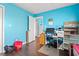 Bright blue bedroom featuring hardwood floors, a window and a desk at 7700 Porcher Dr. # 3205, Myrtle Beach, SC 29572