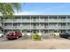 Three-story condo building featuring covered balconies and well-maintained landscaping at 7700 Porcher Dr. # 3205, Myrtle Beach, SC 29572