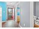 Hallway featuring an open door, wood floors, and a colorful accent wall at 7700 Porcher Dr. # 3205, Myrtle Beach, SC 29572