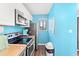 Cozy kitchen featuring blue accent wall, sleek countertops, and modern appliances at 7700 Porcher Dr. # 3205, Myrtle Beach, SC 29572