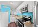 Compact kitchen featuring white cabinets, modern appliances and a functional layout at 7700 Porcher Dr. # 3205, Myrtle Beach, SC 29572