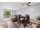 Open floor plan living and dining space featuring wood floors, ceiling fan and patio access at 7700 Porcher Dr. # 3205, Myrtle Beach, SC 29572