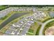 A high up aerial shot shows a residential area with ponds and multiple homes at 798 Woodland Farms Circle, Aynor, SC 29511