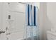 Bathroom view shows a bathtub and shower, with tiled walls and modern fixtures and blue shower curtain at 798 Woodland Farms Circle, Aynor, SC 29511