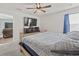 Comfortable bedroom features a wooden bed frame, soft carpet, and a modern ceiling fan at 798 Woodland Farms Circle, Aynor, SC 29511