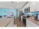 Well-equipped kitchen with granite countertops, white cabinets, stainless steel appliances, and a modern faucet at 798 Woodland Farms Circle, Aynor, SC 29511