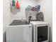 Convenient laundry room with modern Samsung washer and dryer, and ample shelving at 798 Woodland Farms Circle, Aynor, SC 29511