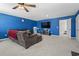 Spacious living room featuring a large TV, comfortable sofa, and neutral carpet flooring at 798 Woodland Farms Circle, Aynor, SC 29511