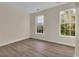 Empty bedroom with hardwood floors and two large windows offering natural light at 945 Rosencrans Ln. # B, Myrtle Beach, SC 29577