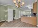 Bright kitchen with an island, adjacent half-bathroom, and open floor plan at 945 Rosencrans Ln. # B, Myrtle Beach, SC 29577