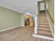 Living room with hardwood floors, stairs leading up, and view of the modern kitchen with stainless appliances at 945 Rosencrans Ln. # B, Myrtle Beach, SC 29577
