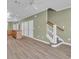 Open-concept living area featuring hardwood floors, stairs to upper level, and access to the kitchen at 945 Rosencrans Ln. # B, Myrtle Beach, SC 29577