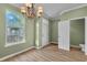 Bright living space with wood floors, a chandelier, and large window for natural light at 945 Rosencrans Ln. # B, Myrtle Beach, SC 29577