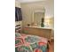 Bedroom features a light dresser with glass top, rattan details, decorative nautical accessories, and a vibrant paisley bedspread at 9501 Shore Dr. # 323, Myrtle Beach, SC 29572
