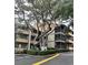 Condo exterior with a sign surrounded by foliage and mature oak trees adding shade to the complex at 9501 Shore Dr. # 323, Myrtle Beach, SC 29572