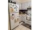 Functional kitchen with appliances, white cabinetry, and a view into the dining area at 9501 Shore Dr. # 323, Myrtle Beach, SC 29572