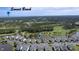 Expansive aerial view of townhomes, golf course, and lush greenery in Sunset Beach at 964 Great Egret Circle Sw # B, Sunset Beach, NC 28468