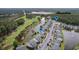 Picturesque view of lakeside townhomes and community amenities including a swimming pool and golf course at 964 Great Egret Circle Sw # B, Sunset Beach, NC 28468