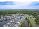 Expansive aerial view of lovely townhomes nestled around a pond and golf course, a scenic community at 964 Great Egret Circle Sw # B, Sunset Beach, NC 28468