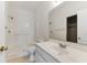 Bright bathroom featuring a walk-in shower with a grab bar, a white vanity, and a neutral color scheme at 964 Great Egret Circle Sw # B, Sunset Beach, NC 28468
