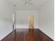 A bright bedroom with hardwood floors includes an ensuite bathroom, shown through an open doorway at 964 Great Egret Circle Sw # B, Sunset Beach, NC 28468