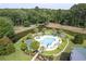 Inviting community pool surrounded by lush greenery and trees, offering a peaceful escape at 964 Great Egret Circle Sw # B, Sunset Beach, NC 28468
