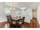 An elegant dining room features a wooden table with seating for six and hardwood floors at 964 Great Egret Circle Sw # B, Sunset Beach, NC 28468