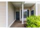 Covered entryway featuring a dark green door and window with dark green shutters at 964 Great Egret Circle Sw # B, Sunset Beach, NC 28468