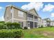 A two-story townhome boasts a charming screened-in porch and well-manicured lawn at 964 Great Egret Circle Sw # B, Sunset Beach, NC 28468