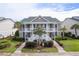 Inviting condo with a lush landscape and white staircases leading to the covered porches at 964 Great Egret Circle Sw # B, Sunset Beach, NC 28468