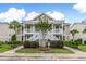 Inviting condo with a lush landscape and white staircases leading to the covered porches at 964 Great Egret Circle Sw # B, Sunset Beach, NC 28468