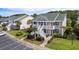 Lovely two-story townhome with white railings, lush landscaping and an inviting entrance at 964 Great Egret Circle Sw # B, Sunset Beach, NC 28468