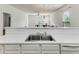 White countertop with a stainless steel sink and view of the dining and living areas at 964 Great Egret Circle Sw # B, Sunset Beach, NC 28468