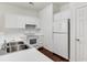 Bright kitchen features white cabinetry, countertops, and stainless steel appliances at 964 Great Egret Circle Sw # B, Sunset Beach, NC 28468