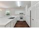 Bright kitchen features white cabinetry, countertops, and stainless steel appliances at 964 Great Egret Circle Sw # B, Sunset Beach, NC 28468