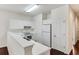Bright kitchen features white cabinetry, countertops, and stainless steel appliances at 964 Great Egret Circle Sw # B, Sunset Beach, NC 28468