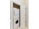 A laundry closet featuring a stacked washer and dryer, maximizing space in a compact and functional design at 964 Great Egret Circle Sw # B, Sunset Beach, NC 28468