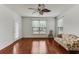 A well-lit living room offers hardwood floors, a ceiling fan, and a view from two windows at 964 Great Egret Circle Sw # B, Sunset Beach, NC 28468