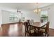 Open-concept living room and dining area with dark wood floors and bright natural light at 964 Great Egret Circle Sw # B, Sunset Beach, NC 28468