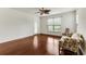 A light-filled living room features hardwood floors and a comfy sofa next to a bright window at 964 Great Egret Circle Sw # B, Sunset Beach, NC 28468